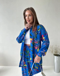 Detail of vibrant tropical floral print on a long-sleeved shirt and trousers set