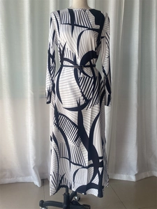 Detail view of long-sleeve dress with modern black geometric print and slim belt