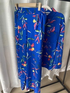 Detail of royal blue floral print shirt and matching trousers set in breathable fabric