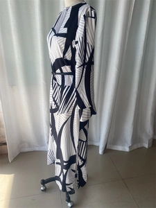 Detail of long-sleeve dress with black and white geometric print and side slit design