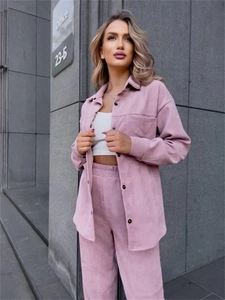 Detailed macro view of pink corduroy fabric on a stylish women's long-sleeve shirt set