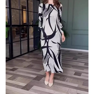 Elegant slim-fit long sleeve midi dress with abstract black and white geometric pattern