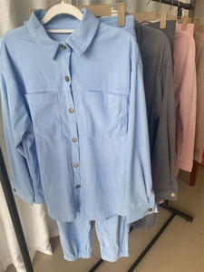 Detail showing various colors of velvet corduroy shirts with metal buttons and pockets