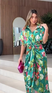 Detail of emerald green floral shirt dress featuring a lapel collar and waist tie belt