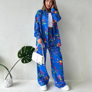 Vibrant blue floral print two-piece set with button-down shirt and wide-leg trousers
