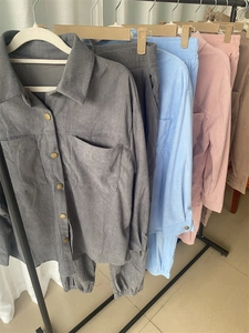 Close-up of heavy corduroy fabric texture and metal buttons on long sleeve shirt sets