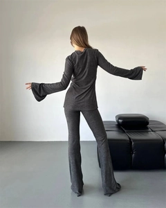 Rear view of slim-fit dark gray knit set with long flared sleeves and bell-bottom pants