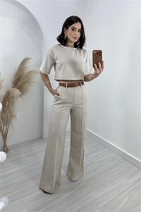 Detail of oatmeal linen crop top and high waist wide leg trousers with slim brown belt