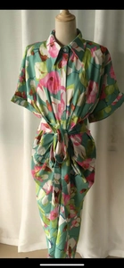Detail of floral printed shirt dress featuring lapel collar and button-down front closure
