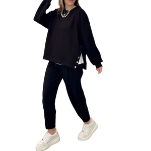 Women's black long sleeve top and jogger set with white button side slit details