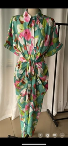 Detail of floral printed casual dress featuring a lapel collar and waist tie belt