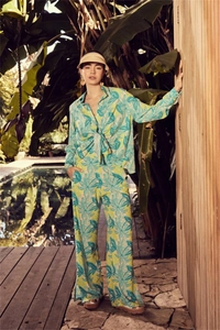 Detail of tropical leaf print on loose long-sleeve shirt and wide-leg pants set