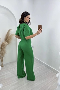 Detail view of the emerald green cotton linen top back button and wide-leg trousers