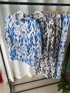 Détail d'un ensemble en satin imprimé avec chemise à manches longues et pantalon large