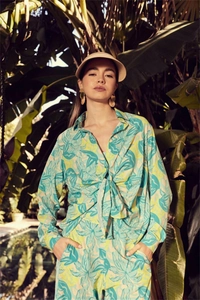 Detail of tropical print long sleeve shirt with tie-front and matching wide-leg trousers