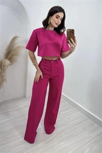 Detail of fuchsia linen-blend set featuring a cropped top and high-waisted trousers