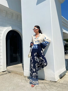 Detail of blue and white floral print texture on casual shirt and wide-leg pants