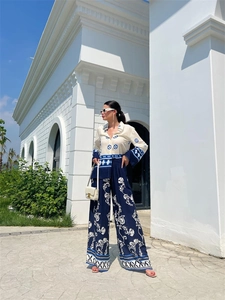 Detail of blue baroque floral pattern on wide-leg trousers for a stylish vacation set
