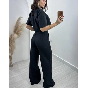 Women's black two-piece set featuring short sleeve cutout top and high waist wide leg pants