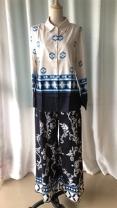 Detail of printed long sleeve shirt and wide leg trousers set with silky satin texture
