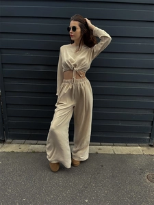 Detailansicht der beigen gerippten Stoffstruktur des Crop-Tops und der weiten Hose