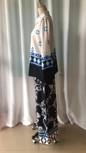 Detail view of printed long sleeve top and wide leg pants set with geometric patterns