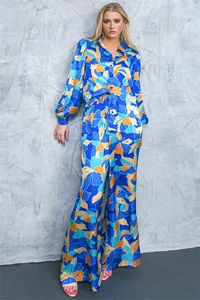 Detail of tropical floral print on silky long sleeve shirt and wide-leg pants set