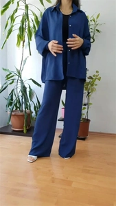 Detail of loose-fit navy blue two-piece set featuring long sleeve shirt and wide-leg pants
