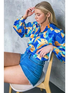Detail view of women's long sleeve floral satin shirt with lantern sleeves and vibrant prints