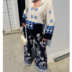 Women's chic two-piece set featuring a beige printed long sleeve top and navy wide-leg pants