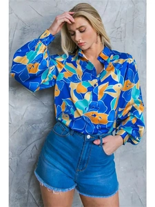 Detail of vibrant blue floral print long sleeve shirt with classic button-down collar
