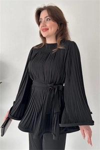 Detail of black pleated long sleeve blouse with elegant waist tie and subtle sheen