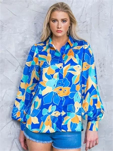 Detail of floral puff sleeve shirt with bold abstract print and button-down lapel collar