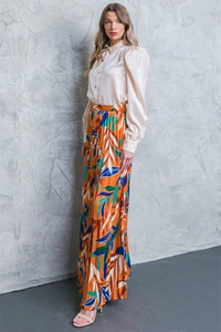 Elegant beige satin shirt with puff sleeves paired with orange floral pleated maxi skirt