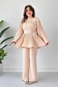 Detail of elegant beige pleated two-piece set featuring waist tie and wide leg trousers
