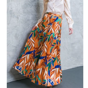 Women's two-piece set featuring a vibrant tropical leaf print pleated maxi skirt and blouse