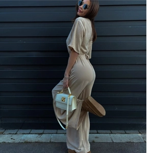 Champagne short sleeve wide leg jumpsuit with waist tie and textured fabric