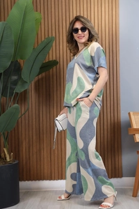 Full body view of women's V-neck top and wide-leg pants set with blue abstract print
