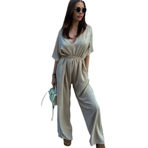Champagne satin V-neck jumpsuit with waist tie and wide legs on white background