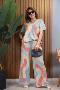 Detail of V-neck short sleeve top and wide leg trousers with colorful abstract waves