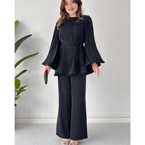 Women's black two-piece set featuring pleated tie-waist top and wide-leg trousers