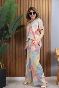 Detail of V-neck short sleeve top and wide-leg trousers with colorful abstract print