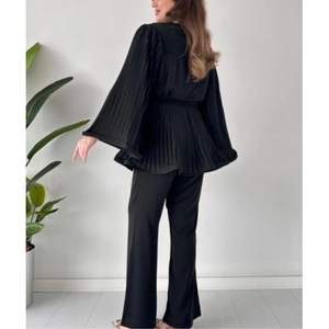 Women's black two-piece set featuring pleated long-sleeve top and matching wide-leg pants