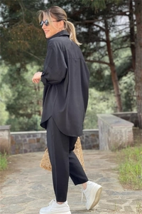 Detail of black long-sleeved shirt and cropped pants set with smooth drape texture
