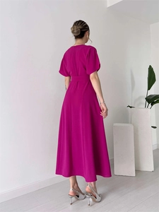 Detailed side view of deep magenta A-line dress showing elegant waist cut and sleek fabric