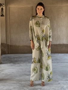 Detail shot of linen set featuring tropical leaf patterns and premium fabric texture
