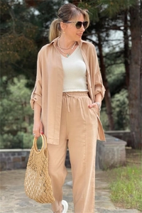 Close-up of khaki long-sleeve shirt and high-waist drawstring wide-leg pants for women