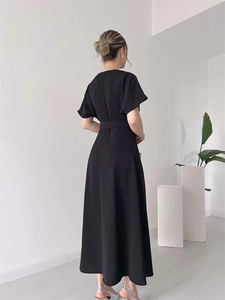 Back view of elegant black maxi dress with short sleeves and waist tie detail