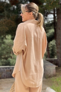 Close-up of beige linen shirt set texture with a drop shoulder and curved hem detail