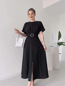 Detailed close-up of a black short-sleeve dress featuring a waist belt with silver buckle